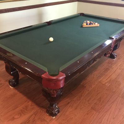 8' Leisureworld pool table. Accessories and Cue Rack. Solid Wood, Slate top. Buyer must pick up.